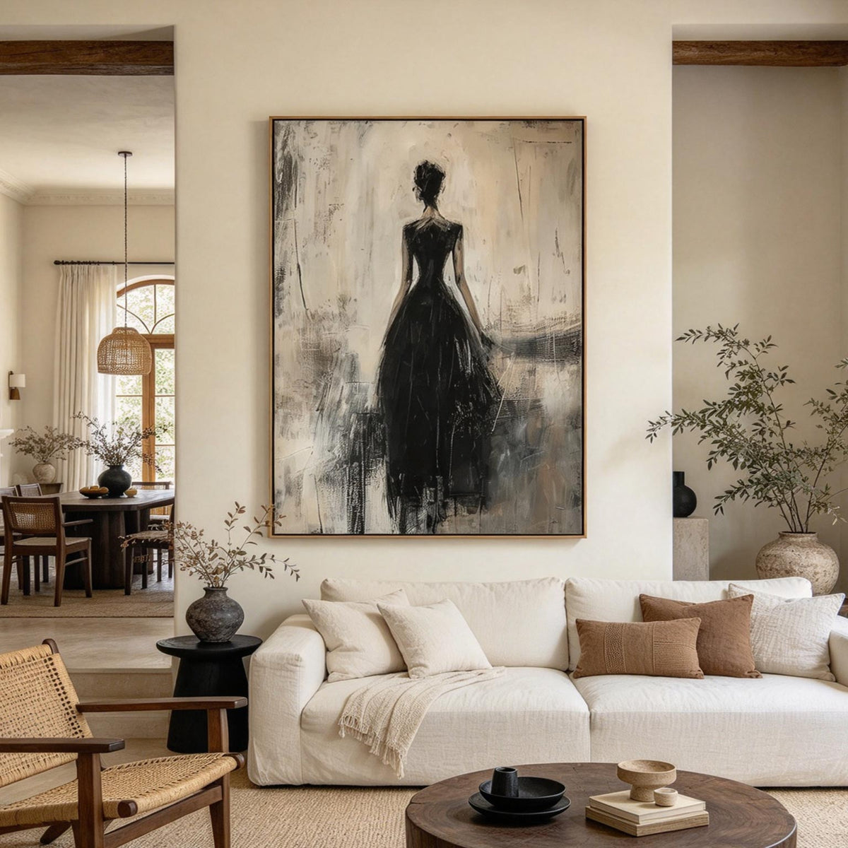 Black gown silhouette painting above a cream sofa in a modern living room