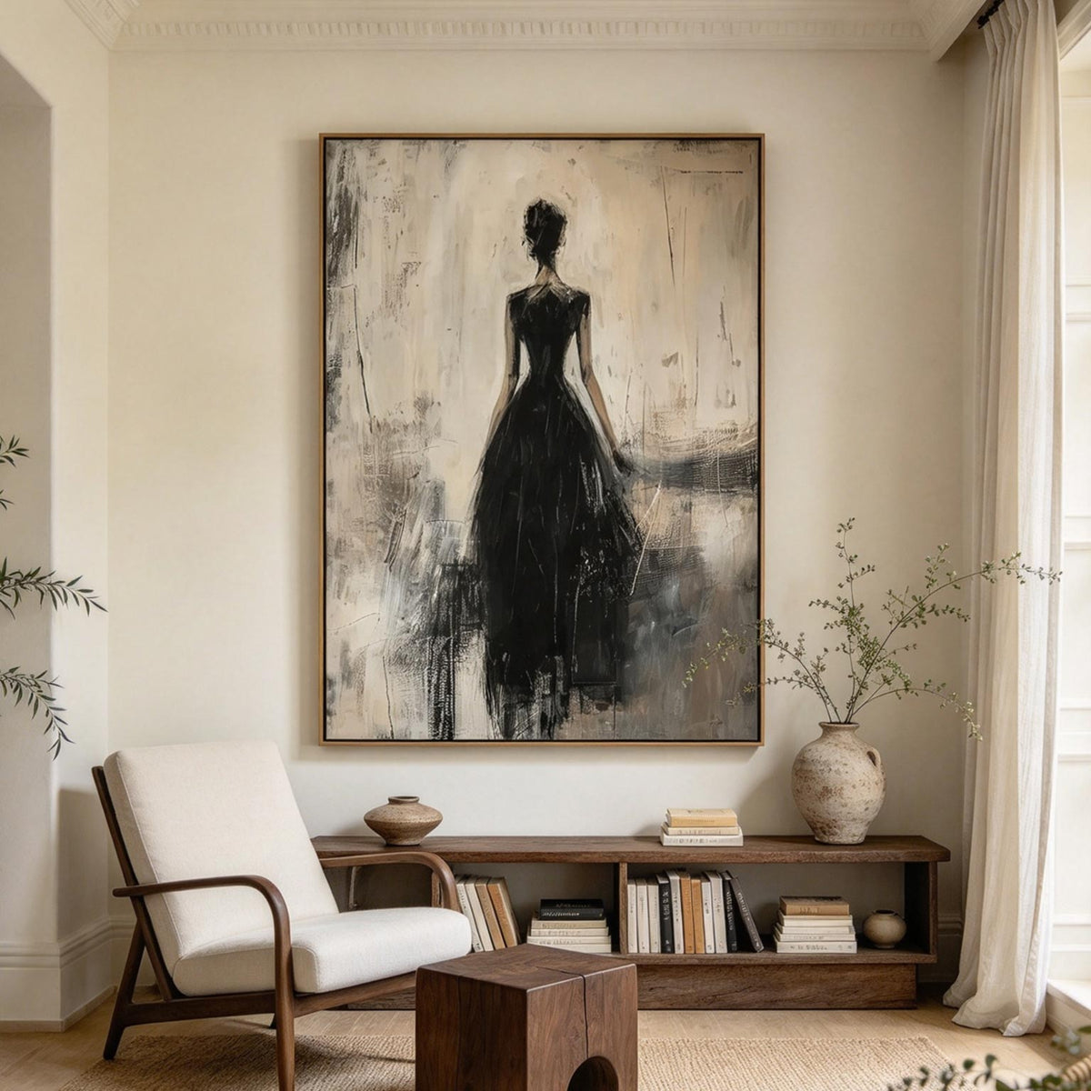 Figurative woman in black dress wall art above a wooden bookshelf and lounge chair